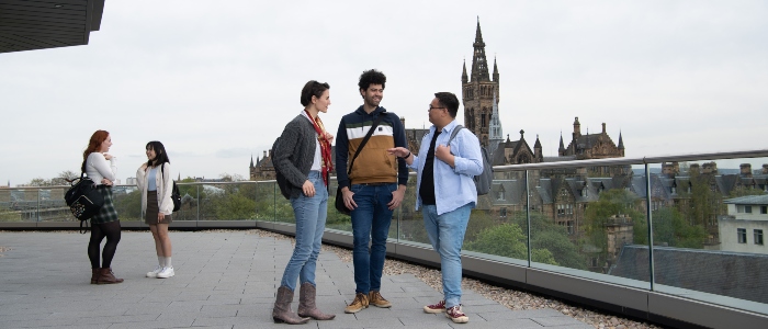 University of Glasgow students on viewing deck with tower in background