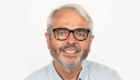 A head of shoulders shot of Professor Tom Evans against a plain, white background