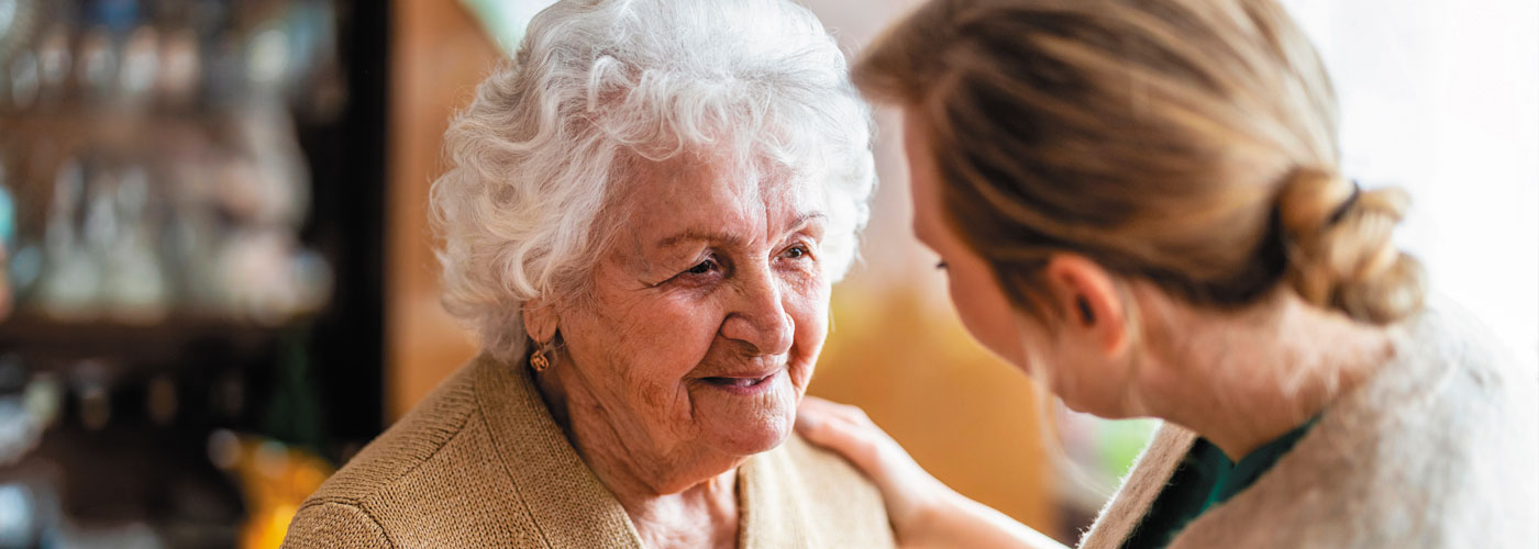 A woman comforts an elderly women