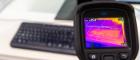 A picture of a thermal camera showing traces of heat on a computer keyboard
