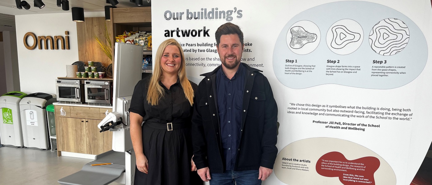 A photo of Shona and Scott Watson standing next to a Byres Hub exhibit