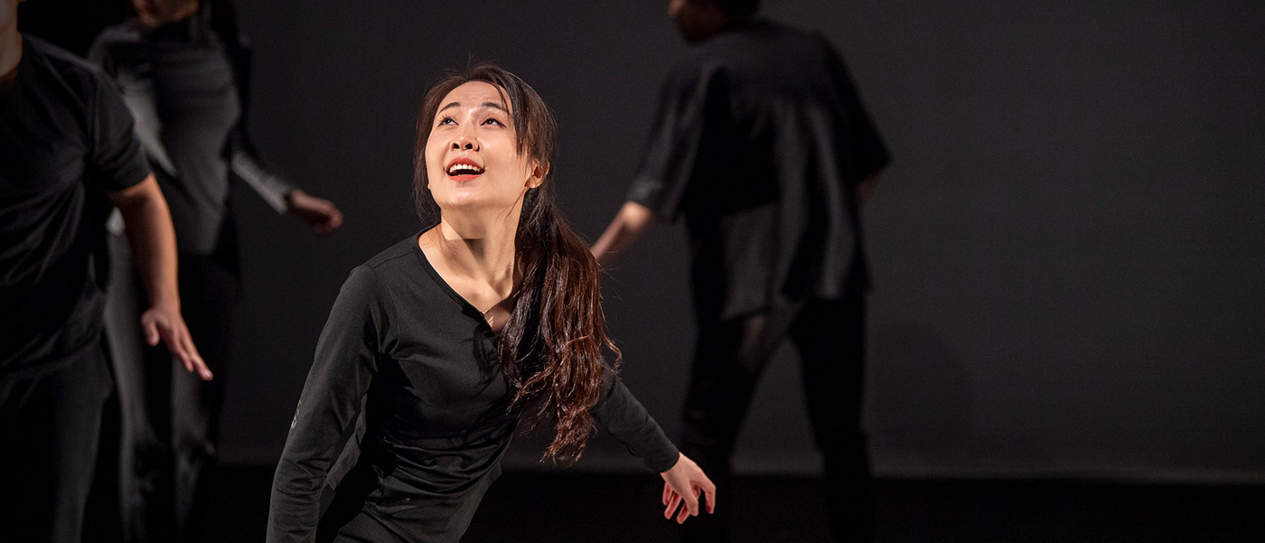 Students performing on a black box stage