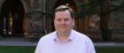 Bruce Jardine standing in the quadrangle at the University of Glasgow for a profile photo