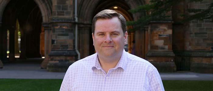 Bruce Jardine standing in the quadrangle at the University of Glasgow for a profile photo