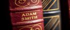 A red book with the name Adam Smith on the spine of the book. Beside is another black and gold book Source: Shutterstock Publisher: B Calkins