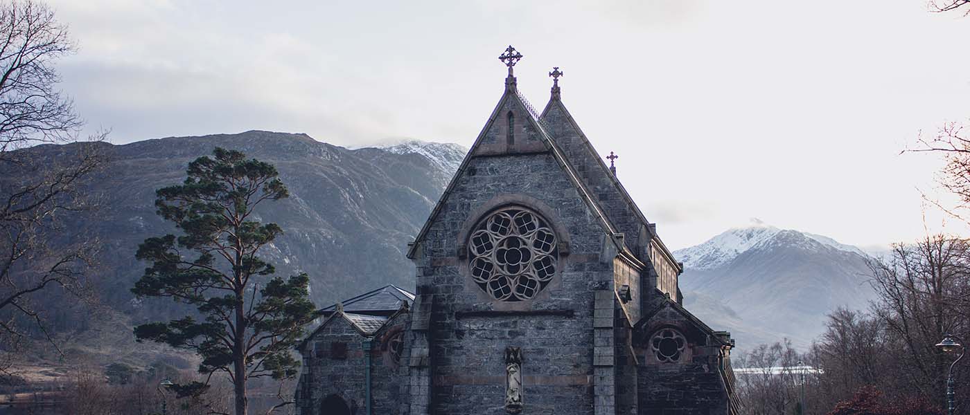 A church in front of mountains