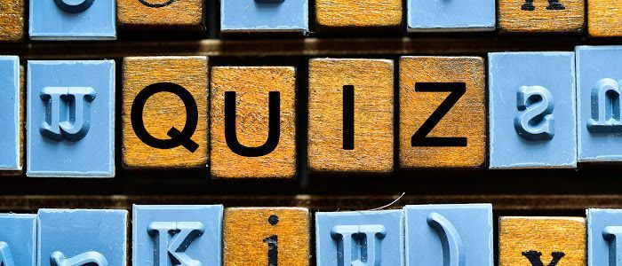 Scrabble tiles laid out to spell "Quiz"