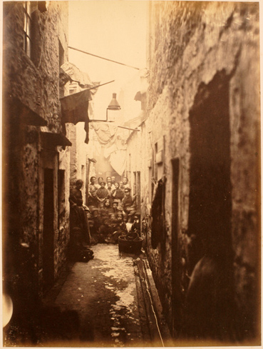Image of plate 15 of Closes and Streets: A crowd of women and children gather to observe Thomas Annan