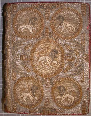 Detail of the beautiful embroidered binding showing the lion motif.